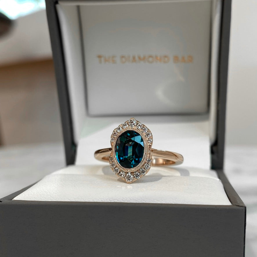 14K Rose Gold Oval Color-Shifting Teal Sapphire and Diamond Halo Ring
