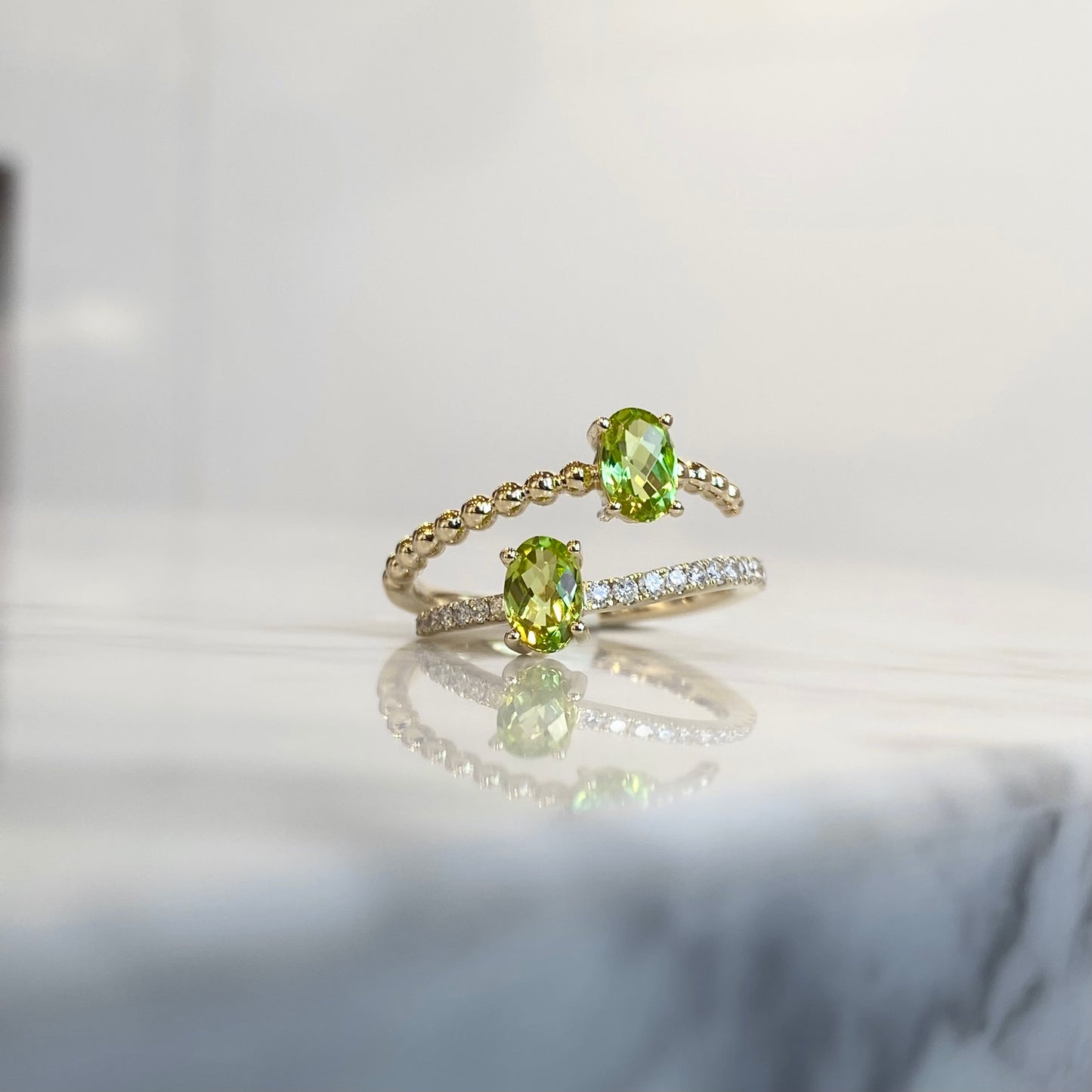 14K yellow gold oval cut peridot and diamond bypass ring