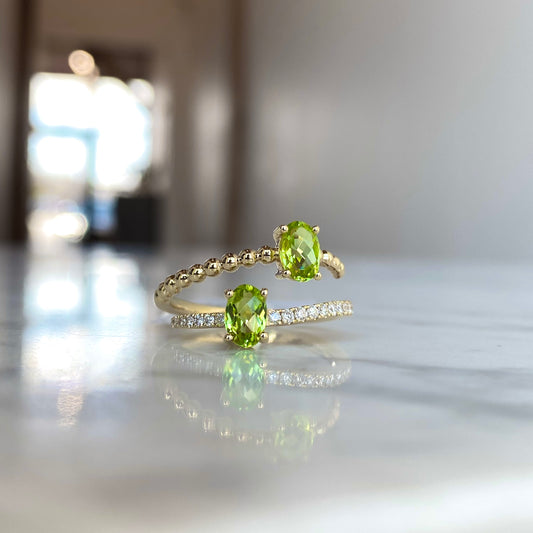 14K yellow gold oval cut peridot and diamond bypass ring