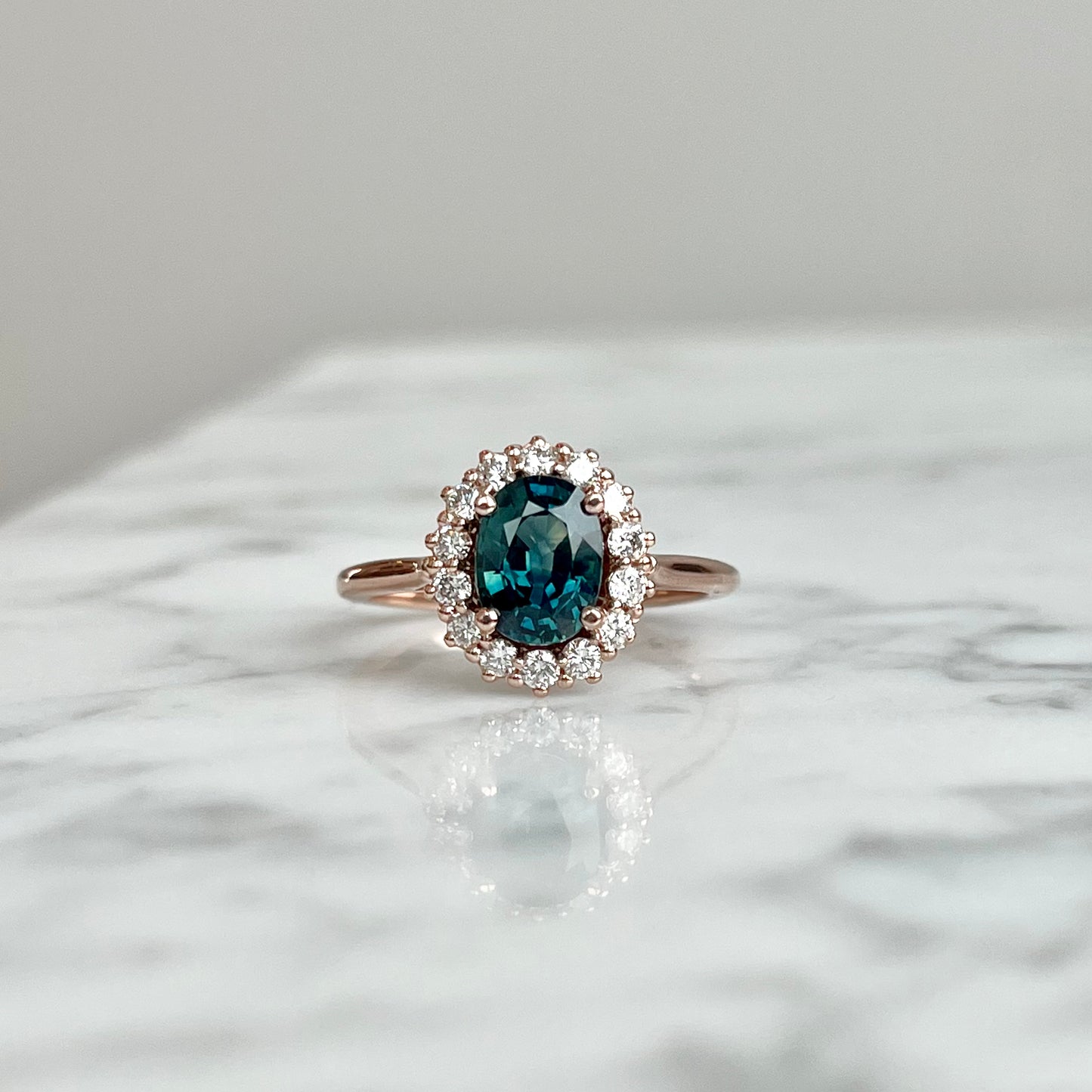 14K Rose Gold Natural Teal Sapphire and Diamond Halo Ring.